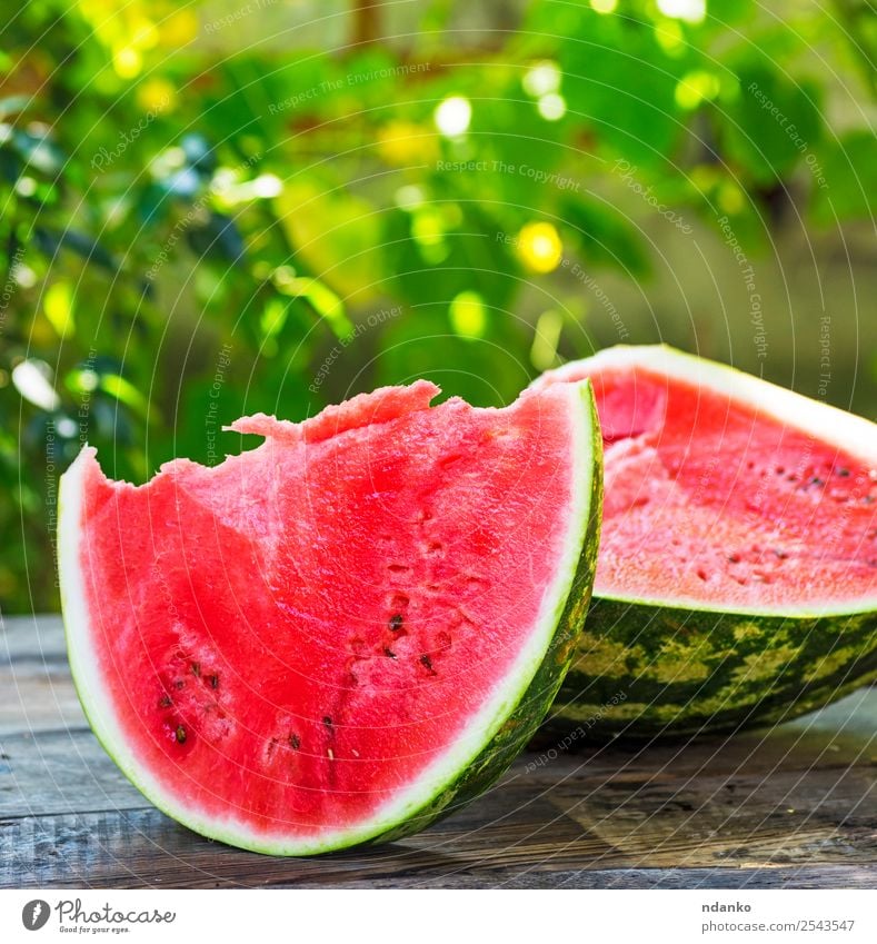 cut a ripe watermelon Fruit Nutrition Vegetarian diet Table Nature Wood Eating Fresh Natural Juicy Green Red Colour Water melon background Slice food sweet