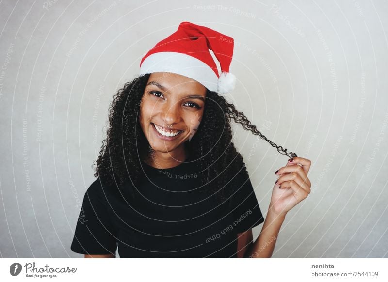 Young happy woman wearing a santa hat Lifestyle Style Design Joy Beautiful Hair and hairstyles Feasts & Celebrations Christmas & Advent New Year's Eve