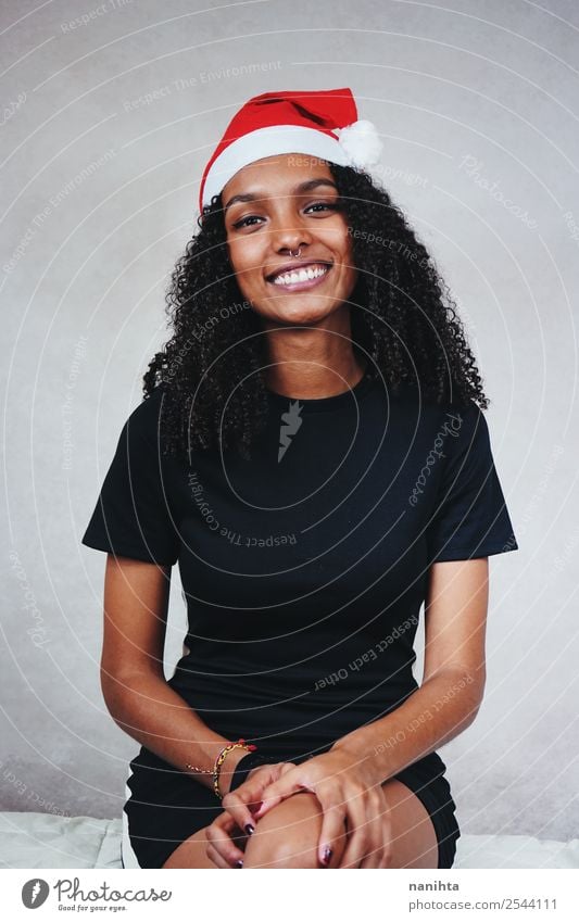 Young happy woman wearing a santa's hat Lifestyle Feasts & Celebrations Christmas & Advent Human being Feminine Young woman Youth (Young adults) Woman Adults 1