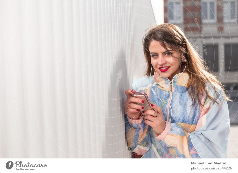 young woman with phone looking at camera Lifestyle Happy Beautiful Music Telephone PDA Camera Technology Human being Woman Adults Smiling Cute Smart