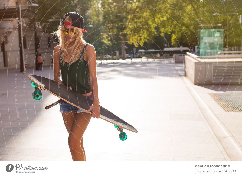 young woman skating in the street Lifestyle Style Joy Beautiful Summer Woman Adults Downtown Street Sunglasses Blonde Cool (slang) Eroticism Hip & trendy casual
