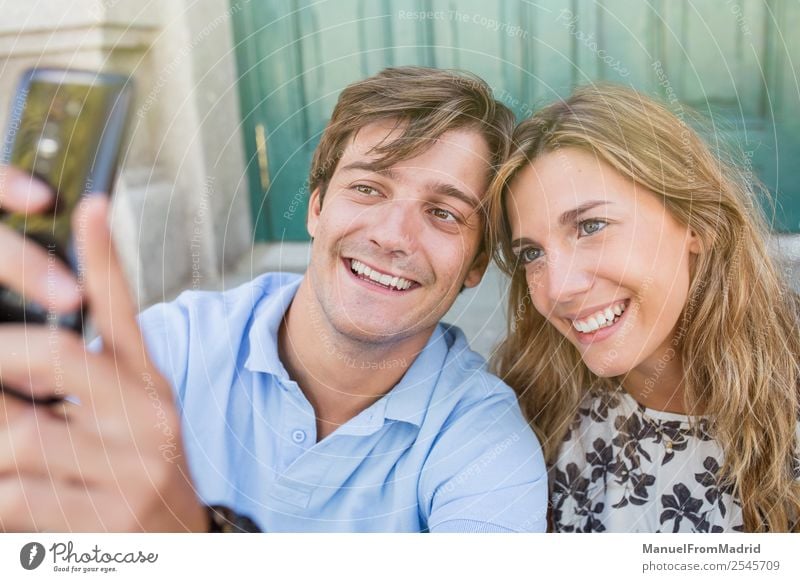 young cheerful couple taking a selfie Lifestyle Joy Happy Beautiful Leisure and hobbies Vacation & Travel Summer Telephone Camera Woman Adults Man Couple