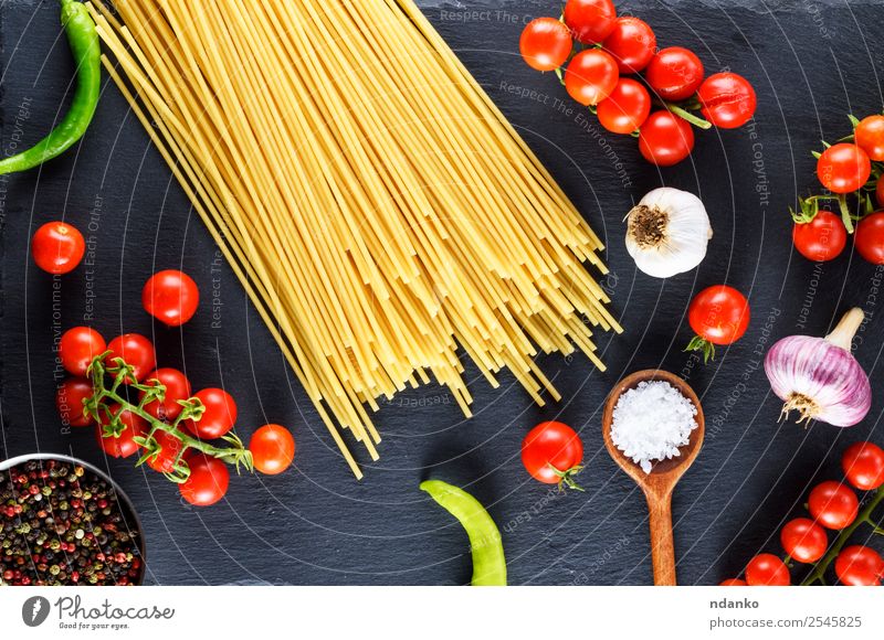 Uncooked pasta spaghetti Vegetable Dough Baked goods Wood Line Fresh Large Long Above Yellow Red Black Colour Tradition Spaghetti food Tomato Cherry Sauce