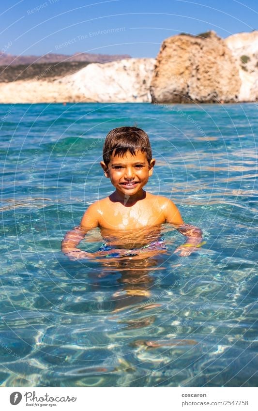 Little boy floating on the sea with transparent water Lifestyle Exotic Joy Happy Beautiful Face Leisure and hobbies Playing Vacation & Travel Summer Beach Ocean