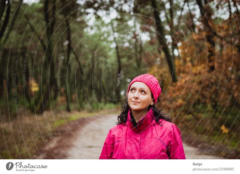Matured woman with wool pink hat in the forest Lifestyle Beautiful Freedom Winter Hiking Human being Woman Adults Nature Autumn Tree Leaf Park Forest