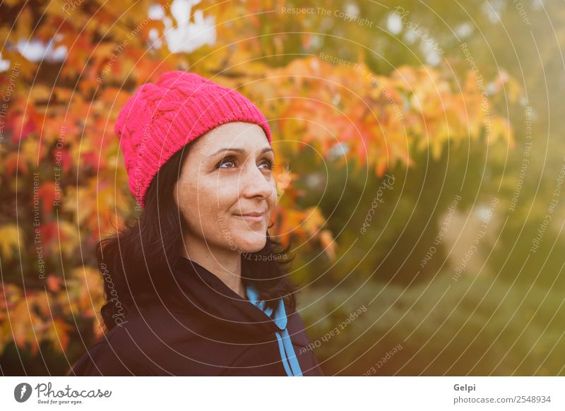 Matured woman with pink wool hat in the forest Lifestyle Beautiful Face Freedom Human being Woman Adults Nature Autumn Tree Leaf Park Forest Fashion Hat