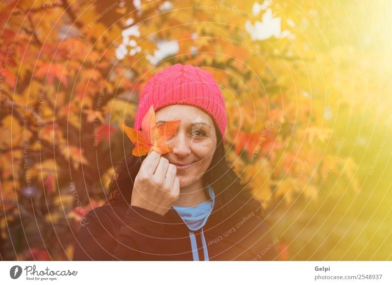 Matured woman with pink wool hat in the forest Lifestyle Beautiful Face Freedom Human being Woman Adults Nature Autumn Tree Leaf Park Forest Fashion Hat