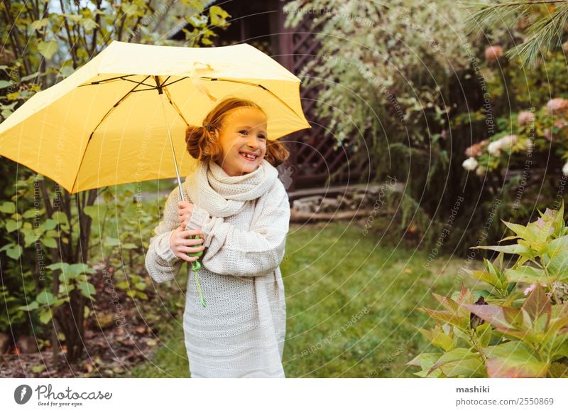 happy kid girl hiding under umbrella Lifestyle Joy Happy Garden Child Infancy Nature Autumn Weather Rain Park Sweater Drop Funny Wet Cute Yellow fall walk
