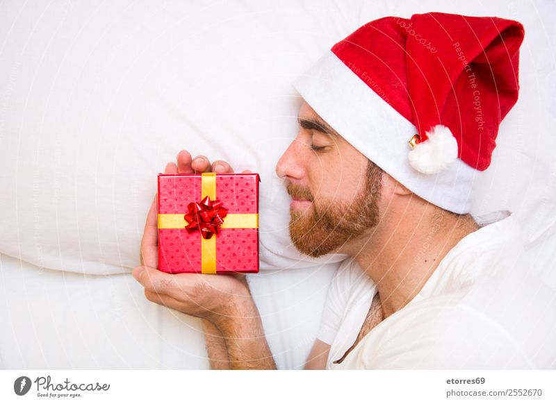 Man with santa hat and gift box Face Vacation & Travel Bed Bedroom Feasts & Celebrations Christmas & Advent Adults Hat Sleep Loneliness Comfortable Attractive