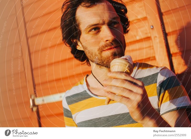 Young man with ice in his hand Ice cream Nutrition Eating Lifestyle Joy Healthy Healthy Eating Well-being Contentment Relaxation Leisure and hobbies