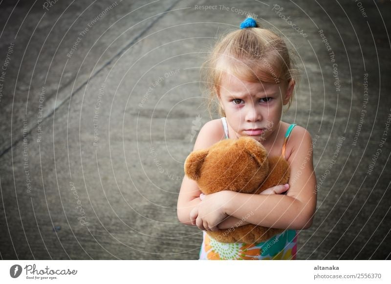 sad little girl holding toy with her hands Face Child Human being Woman Adults Infancy Street Blonde Toys Think Sadness Cute Emotions Concern Grief Fatigue Pain