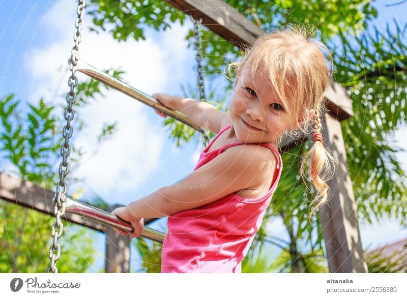 Happy little girl playing on the playground at the day time Lifestyle Joy Face Relaxation Leisure and hobbies Playing Summer Sports Child Human being Woman