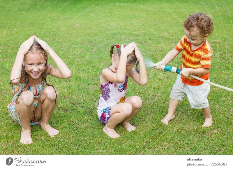 Happy children pours a water Joy Leisure and hobbies Playing Summer House (Residential Structure) Garden Child Human being Boy (child) Man Adults Sister