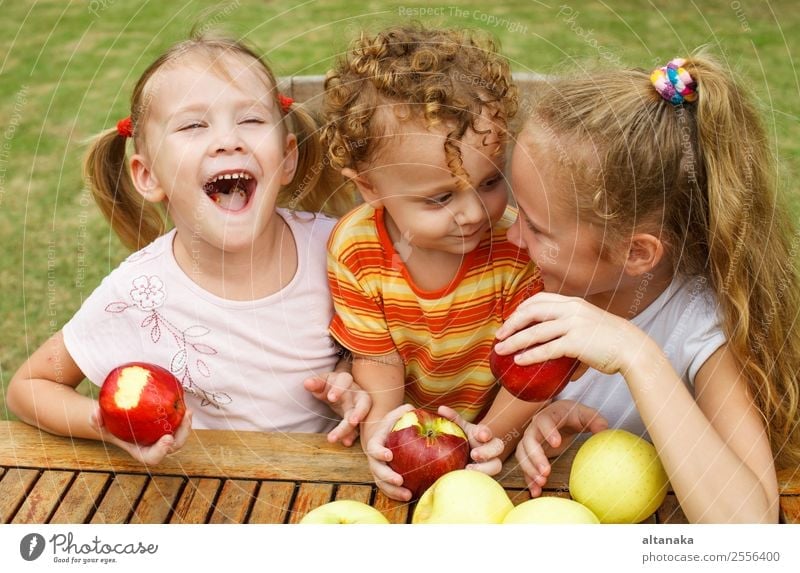 three happy children Fruit Apple Nutrition Eating Diet Lifestyle Joy Happy Beautiful Face Summer Garden Child Human being Baby Boy (child) Woman Adults Infancy