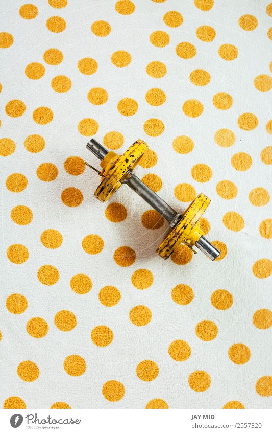Yellow antique weights on a polka dot towel Lifestyle Sports Fitness Sports Training Martial arts Metal Steel Rust Diet Athletic Free Healthy Strong Power