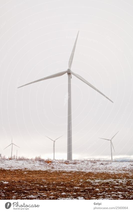Snowy wind park with many high windmills Winter Industry Technology Wind energy plant Environment Nature Landscape Plant Sky Climate Sustainability Blue Green