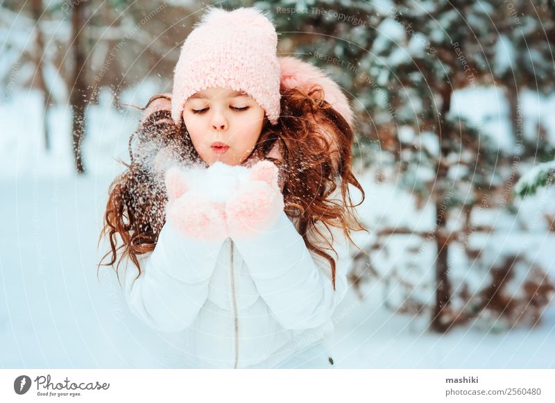 Winter portrait of happy kid girl playing outdoor Joy Vacation & Travel Adventure Freedom Snow Child Infancy Nature Snowfall Tree Park Forest Fashion Clothing
