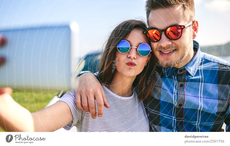 Young couple doing a selfie on the car Lifestyle Happy Beautiful Vacation & Travel Trip Ocean PDA Human being Woman Adults Man Couple Lips Coast Car Kissing