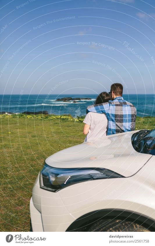 Couple with car watching landscape Lifestyle Vacation & Travel Trip Adventure Ocean Human being Woman Adults Man Nature Landscape Grass Meadow Rock Coast Car