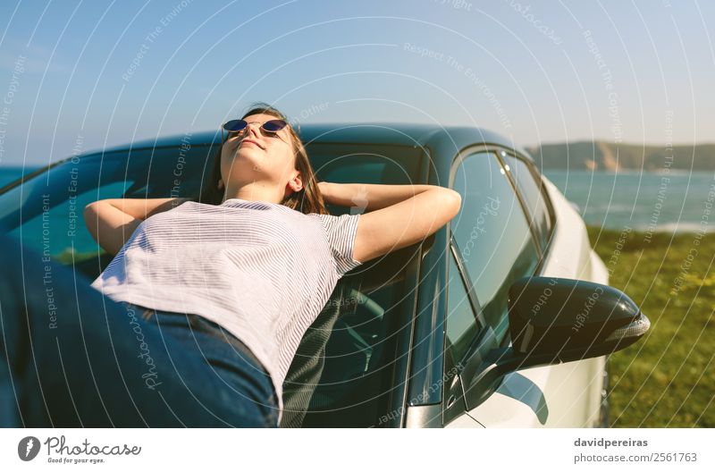 Young girl lying on the windshield Lifestyle Style Happy Beautiful Relaxation Calm Vacation & Travel Sunbathing Ocean Human being Woman Adults