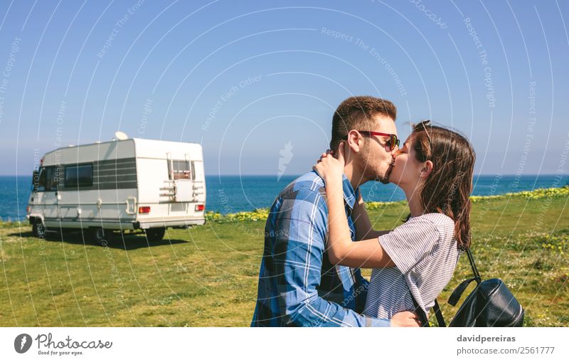 Couple kissing near the coast with a camper Lifestyle Happy Vacation & Travel Adventure Freedom Ocean Human being Woman Adults Man Grass Meadow Coast Kissing