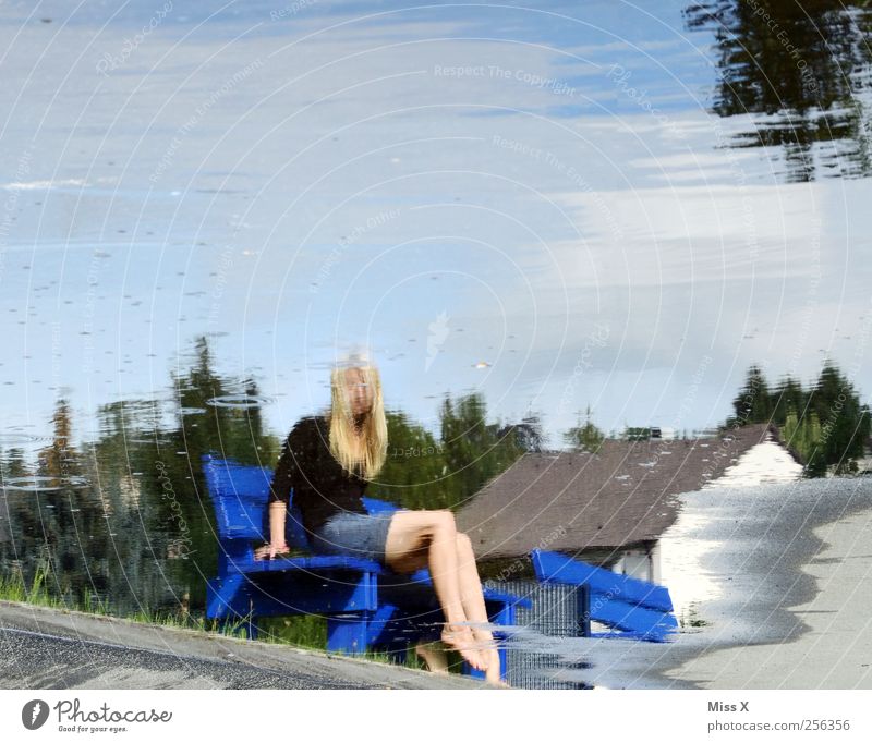 surface world Human being Feminine Woman Adults 1 Water Lake Sit Legs Reflection Water reflection Puddle Park bench Colour photo Exterior shot Motion blur