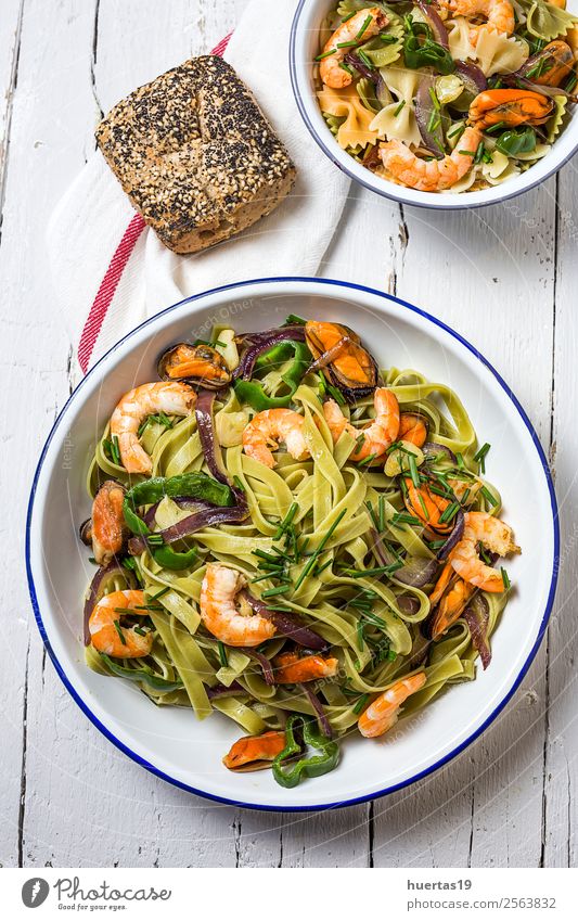 Green tagliatelle with seafood. Food Seafood Vegetable Bread Slow food Italian Food Plate Fork Table Gastronomy Mussel Delicious Sour Yellow Tagliatelle pasta