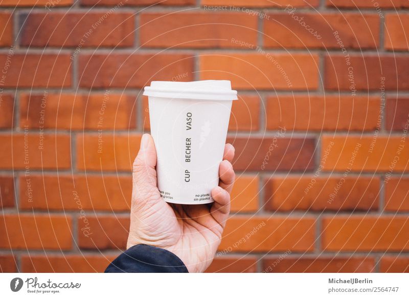 Coffee to go in paper cup with plastic lid Hot drink Hand 1 Human being Environment Environmental pollution Environmental protection Germany Hamburg Plastic
