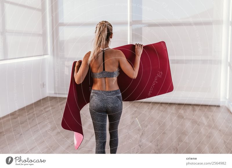 young woman preparing fitness mat for some excercise Lifestyle Beautiful Body Wellness Relaxation Sports Yoga Human being Woman Adults Band Underwear Movement