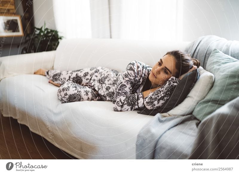 caucasian woman lying on sofa at home Lifestyle Style Happy Beautiful Relaxation Calm Sofa Living room Human being Woman Adults Think Sleep Dream Modern Couch