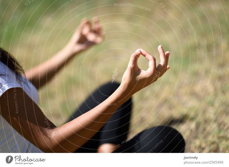 Young woman doing yoga on the grass of urban park. Lifestyle Relaxation Calm Meditation Summer Sports Yoga Human being Feminine Youth (Young adults) Woman