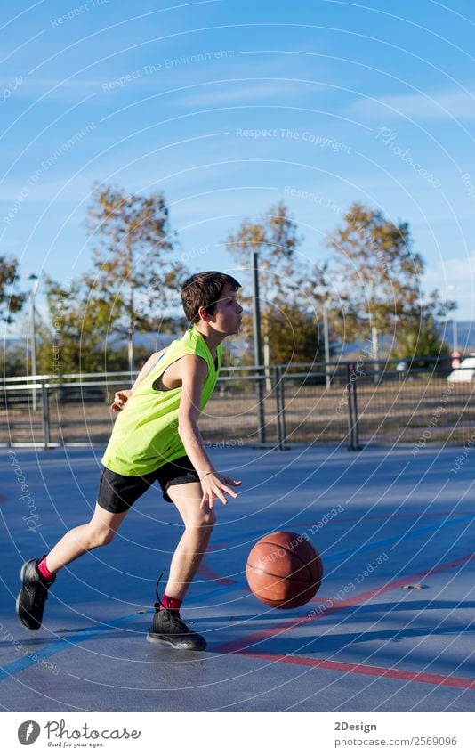 Teenage playing basketball on an outdoors court Lifestyle Joy Relaxation Leisure and hobbies Playing Sports Human being Masculine Boy (child) Man Adults 1