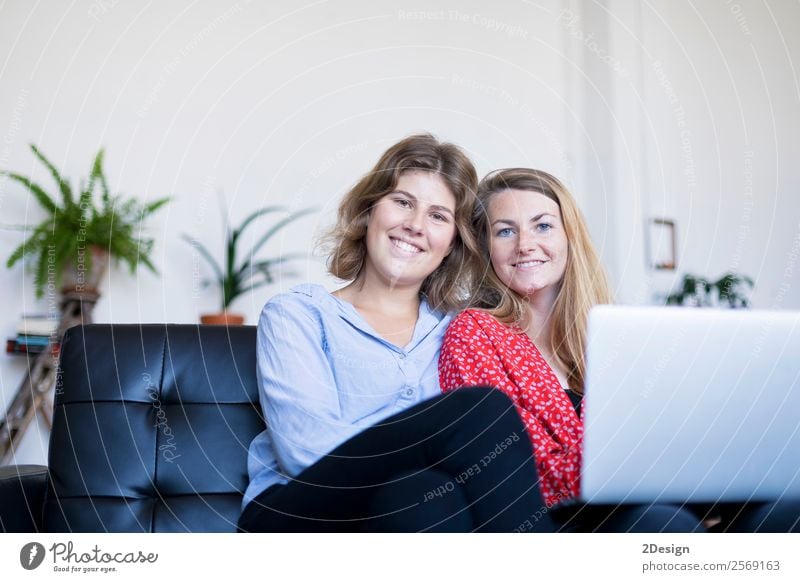 Two smiling young woman sitting on the sofa with laptop. Lifestyle Happy Beautiful House (Residential Structure) Sofa Work and employment Computer Notebook
