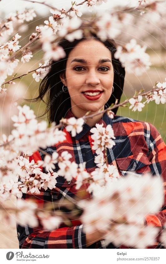 Brunette girl near a almond tree with many flowers Style Happy Beautiful Face Garden Human being Woman Adults Nature Tree Flower Blossom Park Fashion Smiling