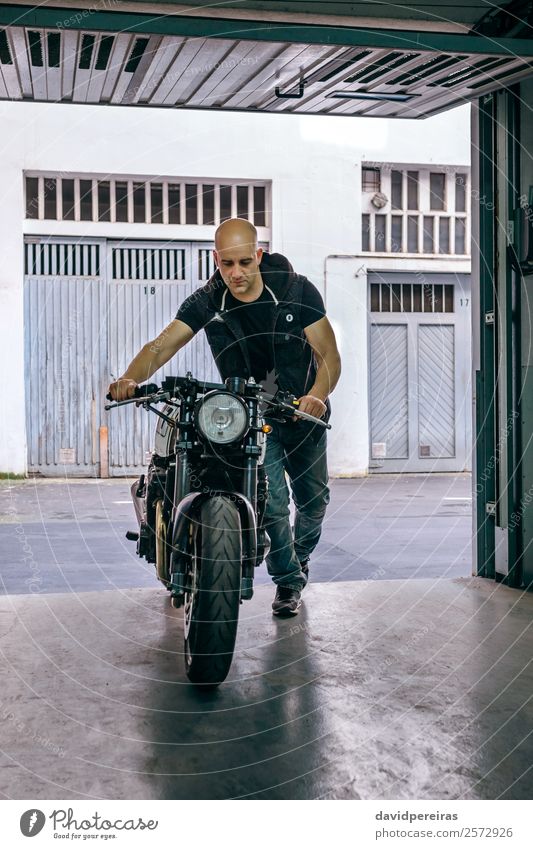 Biker taking motorbike to the garage Lifestyle Style Vacation & Travel Trip Engines Human being Man Adults Transport Street Vehicle Motorcycle Jeans