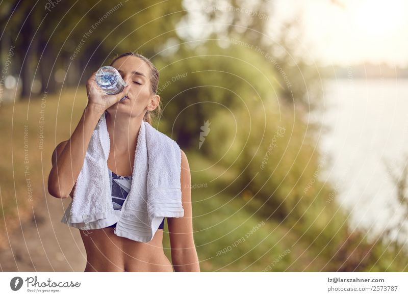 Fit sporty woman drinking water from a bottle Bottle Sports Woman Adults 1 Human being 18 - 30 years Youth (Young adults) Park Fitness Athletic training young