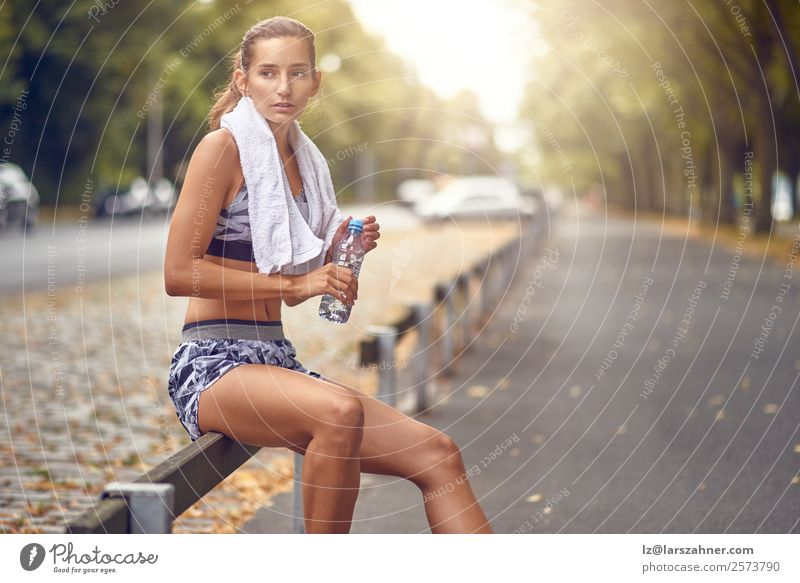 Happy fit woman taking a break from jogging Drinking Lifestyle Summer Sports Jogging Woman Adults 1 Human being 18 - 30 years Youth (Young adults) Warmth Street