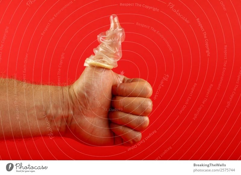 Close up man hand showing thumb up with condom on finger Healthy Health care Masculine Young man Youth (Young adults) Man Adults Hand Fingers 1 Human being