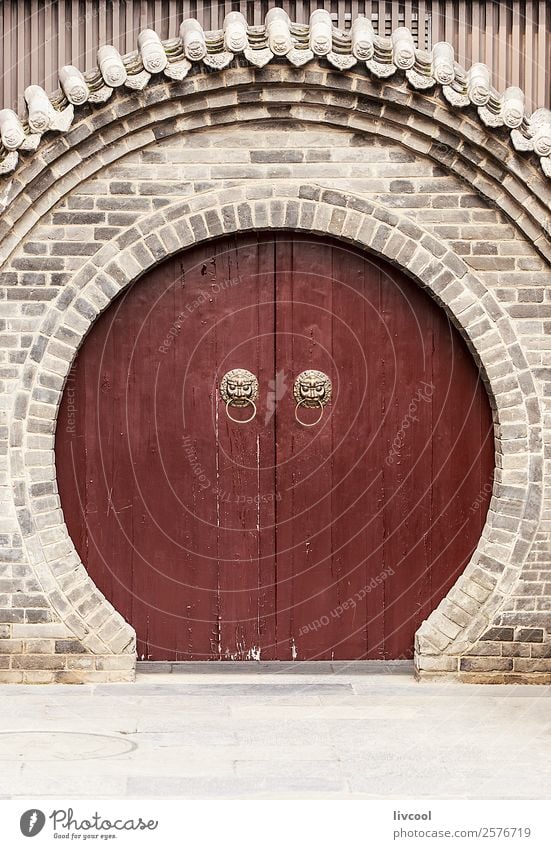circular china door, chinese wall in xian Face Art Animal Town Places Building Architecture Door Monument Street Wood Historic Brown Gray Religion and faith