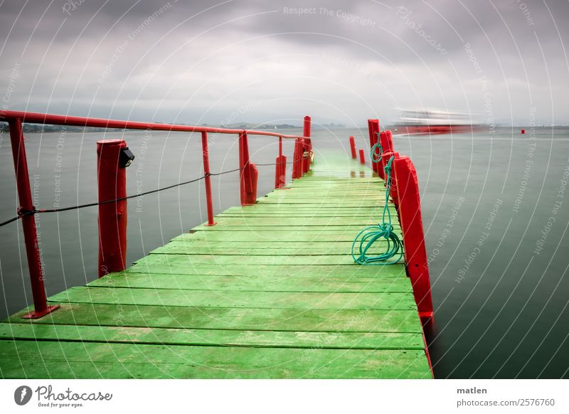 the small ferry Landscape Clouds Horizon Summer Ocean Navigation Driving Gray Green Red Jetty Footbridge Rope Ferry Colour photo Exterior shot Copy Space left