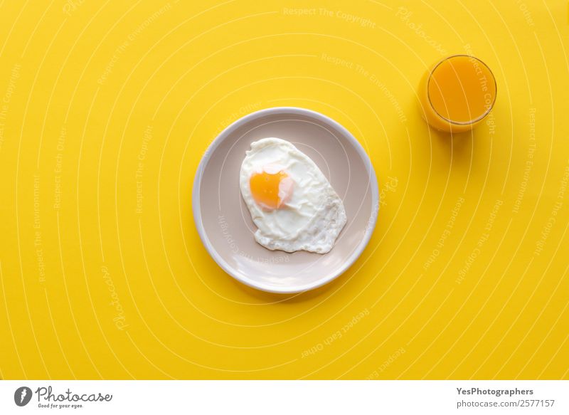 Fried egg and orrange juice Food Nutrition Breakfast Lunch Diet Beverage Juice Plate Fresh Healthy Good Bright Delicious Yellow above view Cooking Copy Space