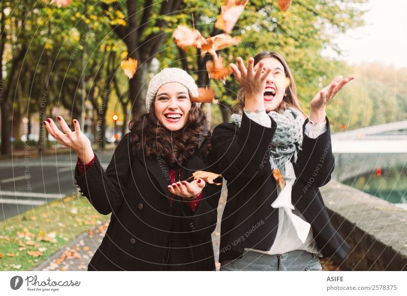 Girls crazy for autumn Lifestyle Joy Happy Beautiful Woman Adults Friendship Youth (Young adults) Autumn Leaf Fashion Scarf Smiling Laughter Cool (slang)