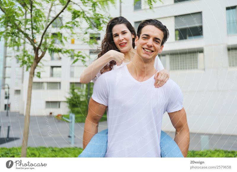 Beautiful young couple looking at camera and smiling Lifestyle Style Happy Leisure and hobbies Summer Telephone Cellphone PDA Human being Masculine Feminine