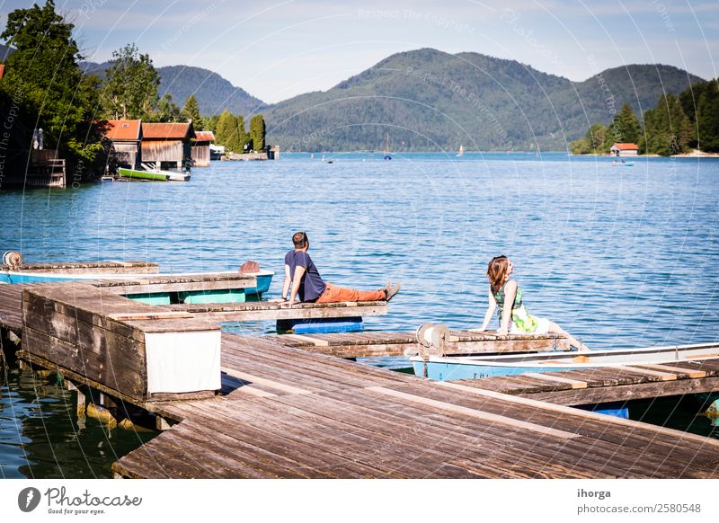 Two happy lovers on vacation at the pier on a lake Lifestyle Happy Beautiful Relaxation Vacation & Travel Adventure Summer Mountain Woman Adults Man Couple