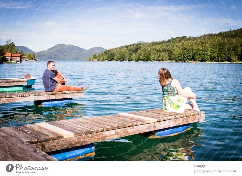Two happy lovers on vacation at the pier on a lake Lifestyle Happy Beautiful Relaxation Vacation & Travel Adventure Summer Mountain Woman Adults Man Couple