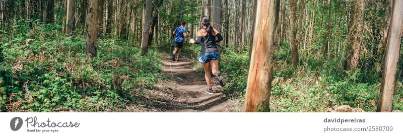 Young woman and man doing trail Lifestyle Adventure Sports Human being Woman Adults Man Couple Nature Tree Forest Lanes & trails Fitness Authentic Speed Effort