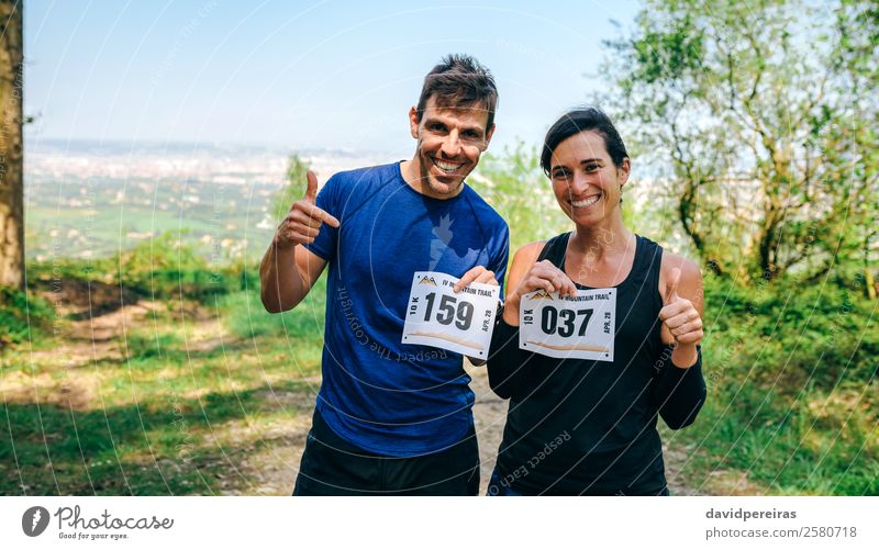 Man and woman showing their trail race number Lifestyle Happy Sports Success Human being Woman Adults Friendship Couple Nature Forest Lanes & trails Smiling