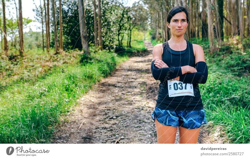 Female trail athlete posing with race number Lifestyle Beautiful Sports Human being Woman Adults Nature Tree Forest Lanes & trails Authentic Self-confident