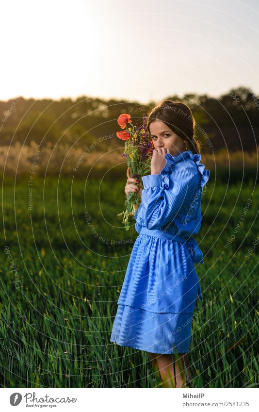 Feeling a little shy. Human being Young woman Youth (Young adults) Nature Plant Flower Fashion Dress Earring Bouquet Stripe Stand Blue Green Red girl Caucasian