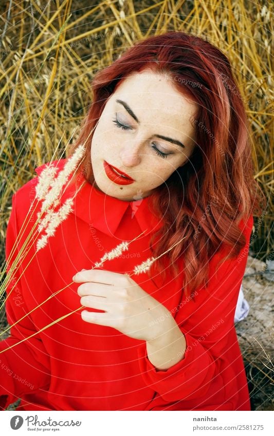 Young woman in nature wearing a red dress Lifestyle Elegant Style Beautiful Hair and hairstyles Skin Face Human being Feminine Youth (Young adults) Woman Adults